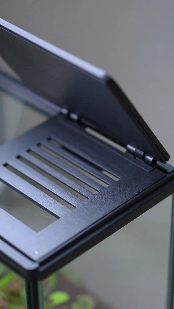 closeup of airflow vent lid slightly open on glass terrarium