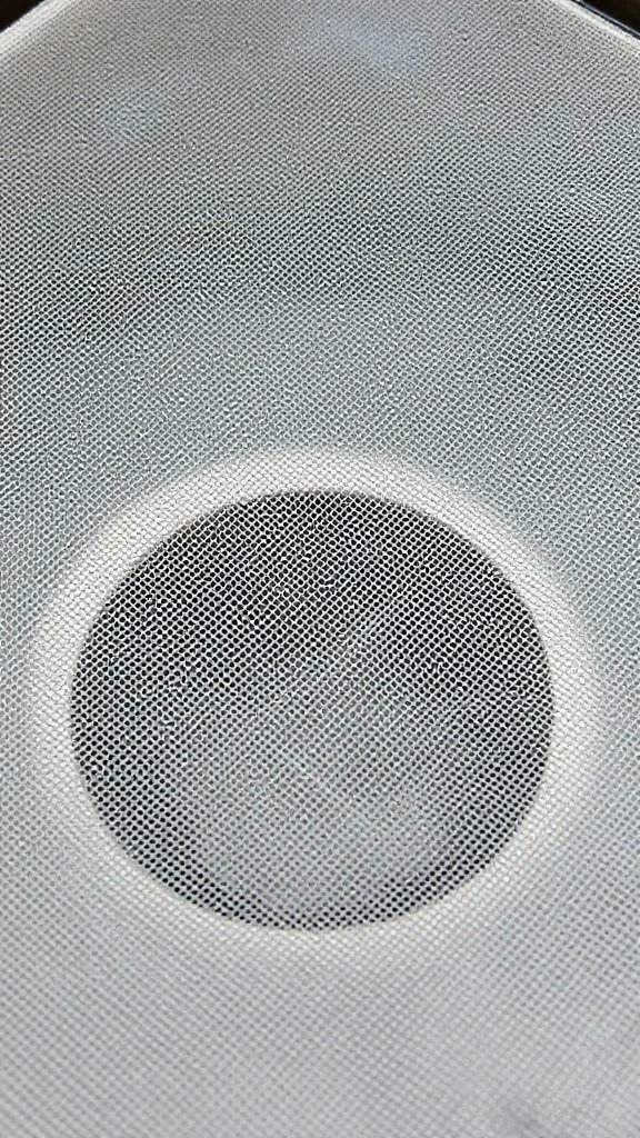 single mesh screen over pot drainage hole, macro