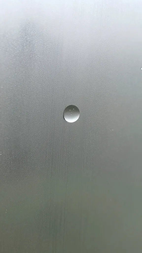 single condensation droplet on greenhouse pane, macro